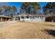 Charming ranch home with gray exterior, covered porch, and well-manicured lawn at 3582 Swallow Ln, Decatur, GA 30032