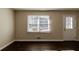 Living room with hardwood floors, large window, and neutral walls at 3582 Swallow Ln, Decatur, GA 30032