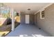 Covered side patio with concrete flooring and exterior door at 3582 Swallow Ln, Decatur, GA 30032