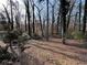 A secluded wooded backyard offers a private retreat surrounded by nature's beauty at 6070 Blackhawk Se Trl, Mableton, GA 30126
