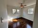 Sunny bedroom with hardwood floors, bright white walls, and multiple windows at 6070 Blackhawk Se Trl, Mableton, GA 30126