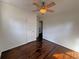 Cozy bedroom featuring hardwood floors, white walls, and a ceiling fan at 6070 Blackhawk Se Trl, Mableton, GA 30126