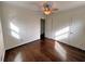 This bedroom features hardwood floors, two windows, and neutral-colored walls at 6070 Blackhawk Se Trl, Mableton, GA 30126