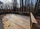 A spacious wooden deck with wooden and black metal railings, offering a serene outdoor living space at 6070 Blackhawk Se Trl, Mableton, GA 30126