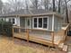 Charming single-story home with gray siding and wooden deck; a cozy outdoor space at 6070 Blackhawk Se Trl, Mableton, GA 30126