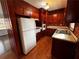 Functional kitchen with white appliances, wood cabinets, and ample counter space at 6070 Blackhawk Se Trl, Mableton, GA 30126