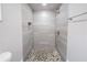 Walk-in shower with pebble floor and modern fixtures at 3693 Aldea Dr, Decatur, GA 30032