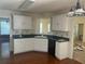 Kitchen with white cabinets, granite countertops, and hardwood floors at 7115 Shady Oak Ln, Cumming, GA 30040