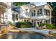 Curved pool with waterfall feature and patio with seating at 981 Fairfield Dr, Marietta, GA 30068