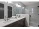 Bathroom with double vanity, gray tile, and glass shower at 244 Castleberry Station Sw Dr, Atlanta, GA 30313