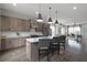 Open kitchen with island, stainless steel appliances, and wood cabinets at 244 Castleberry Station Sw Dr, Atlanta, GA 30313