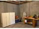 Basement storage area with cabinets and workbench at 2022 Cheyanne Se Dr, Smyrna, GA 30080