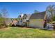 Well-manicured backyard showcases the home's exterior and surrounding landscape at 701 Vinings Estates Se Dr, Smyrna, GA 30126