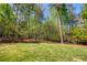 Secluded backyard surrounded by mature trees offers a private oasis at 701 Vinings Estates Se Dr, Smyrna, GA 30126
