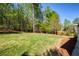 Lush backyard showing level lawn and wooded boundary at 701 Vinings Estates Se Dr, Smyrna, GA 30126