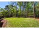 Large backyard area featuring a well-maintained lawn and mature trees at 701 Vinings Estates Se Dr, Smyrna, GA 30126