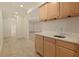 Basement bar area boasts wood cabinets and marble countertops with an open-concept at 701 Vinings Estates Se Dr, Smyrna, GA 30126