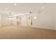 Finished basement includes neutral carpet, modern lighting and an open floorplan at 701 Vinings Estates Se Dr, Smyrna, GA 30126