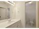 Well-lit bathroom with a single vanity sink and a door leading to the toilet at 701 Vinings Estates Se Dr, Smyrna, GA 30126
