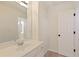 Bright bathroom featuring a single vanity sink with a door at 701 Vinings Estates Se Dr, Smyrna, GA 30126