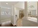 Luxurious bathroom featuring a soaking tub, glass shower, and elegant design at 701 Vinings Estates Se Dr, Smyrna, GA 30126