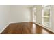 Bedroom with hardwood floors, white walls, and two windows providing ample natural light at 701 Vinings Estates Se Dr, Smyrna, GA 30126