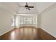 Generous bedroom offers tray ceilings, hardwood floors, and a wall of windows at 701 Vinings Estates Se Dr, Smyrna, GA 30126