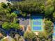Aerial view showcasing tennis courts and a basketball court in a wooded area at 701 Vinings Estates Se Dr, Smyrna, GA 30126