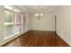 Dining room featuring hardwood floors, a chandelier, wainscoting, and large windows at 701 Vinings Estates Se Dr, Smyrna, GA 30126