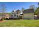 Exterior view of the back of the home showcasing the deck, lush lawn, and architectural design at 701 Vinings Estates Se Dr, Smyrna, GA 30126