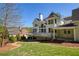 Exterior view of the back of the house featuring the deck, patio, and well-manicured backyard at 701 Vinings Estates Se Dr, Smyrna, GA 30126