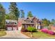 Beautiful brick home with a three car garage and a landscaped front yard at 701 Vinings Estates Se Dr, Smyrna, GA 30126