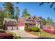 Charming brick home with a three car garage and a well-maintained lawn at 701 Vinings Estates Se Dr, Smyrna, GA 30126