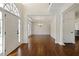 Spacious foyer with hardwood floors leading to a dining area with a chandelier and white wainscoting at 701 Vinings Estates Se Dr, Smyrna, GA 30126