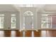 Bright foyer with hardwood floors, white walls, arched entry, and large windows providing ample natural light at 701 Vinings Estates Se Dr, Smyrna, GA 30126