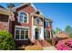 Close-up view of front of home with a brick facade and front garden at 701 Vinings Estates Se Dr, Smyrna, GA 30126