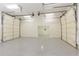 Spacious garage with bright lighting, epoxy flooring, and automatic doors at 701 Vinings Estates Se Dr, Smyrna, GA 30126