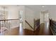 Bright hallway featuring hardwood floors, elegant railings, and decorative chandelier at 701 Vinings Estates Se Dr, Smyrna, GA 30126