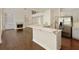 Kitchen with stainless steel appliances and breakfast bar open to the living room and fireplace at 701 Vinings Estates Se Dr, Smyrna, GA 30126