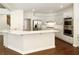 Open kitchen with stainless steel appliances, white cabinets, and marble countertops at 701 Vinings Estates Se Dr, Smyrna, GA 30126