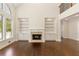 Living room featuring hardwood floors, a fireplace with built-ins, and expansive windows with outdoor views at 701 Vinings Estates Se Dr, Smyrna, GA 30126