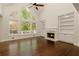 Living room featuring hardwood floors, a fireplace with built-ins, and expansive arched windows with outdoor views at 701 Vinings Estates Se Dr, Smyrna, GA 30126
