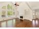 Living room featuring hardwood floors, a fireplace with built-ins, and expansive arched windows with outdoor views at 701 Vinings Estates Se Dr, Smyrna, GA 30126