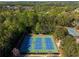 Aerial view of community tennis courts surrounded by lush trees at 701 Vinings Estates Se Dr, Smyrna, GA 30126