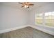 Well-lit bedroom featuring a ceiling fan and double window at 153 Oak St, Hiram, GA 30141
