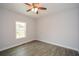 Bright bedroom with ceiling fan, wood-look floors, and window at 153 Oak St, Hiram, GA 30141