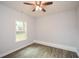Bright bedroom with ceiling fan, wood-look flooring, and large window at 153 Oak St, Hiram, GA 30141