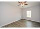 Bright bedroom with ceiling fan, wood-look floors, and window at 153 Oak St, Hiram, GA 30141
