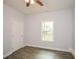 Bedroom with ceiling fan, wood-look flooring, window, and closet at 153 Oak St, Hiram, GA 30141