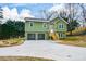 New construction green house, two-car garage and a large front yard at 153 Oak St, Hiram, GA 30141